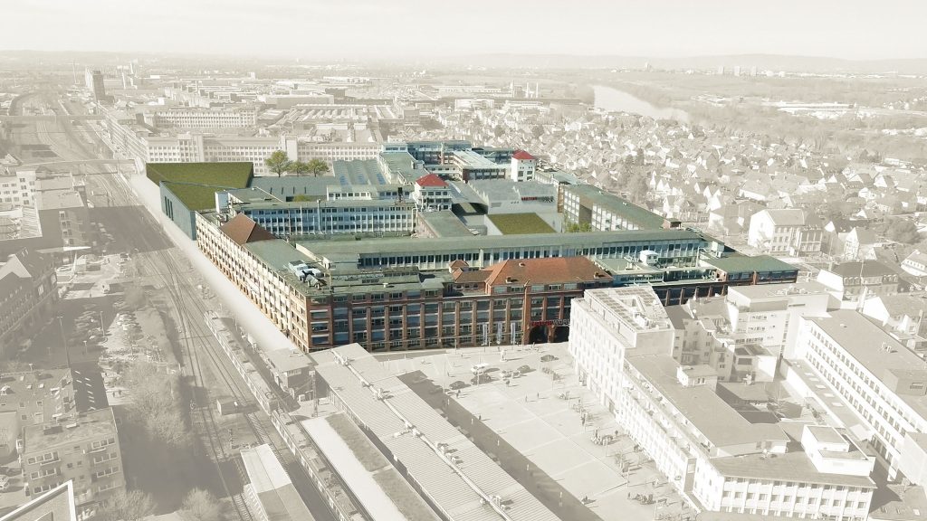 Luftaufnahme einer großen Eventlocation in urbaner Umgebung mit umliegenden Gebäuden und Zuglinien