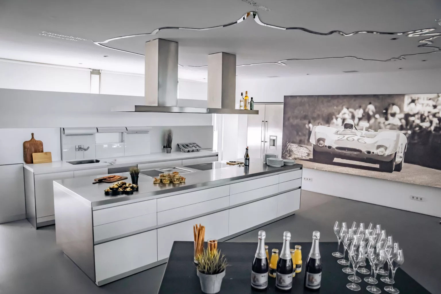 Modern event location with minimalist cuisine, buffet and large motorsport photography on the wall