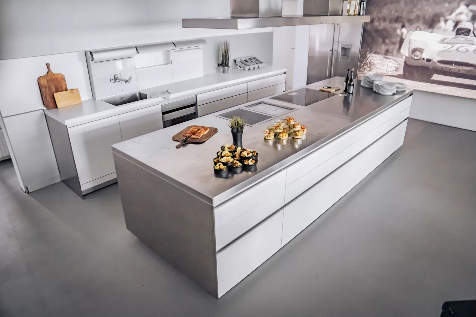 Modern kitchen event location with large cooking island and preparation for catering with snacks and drinks