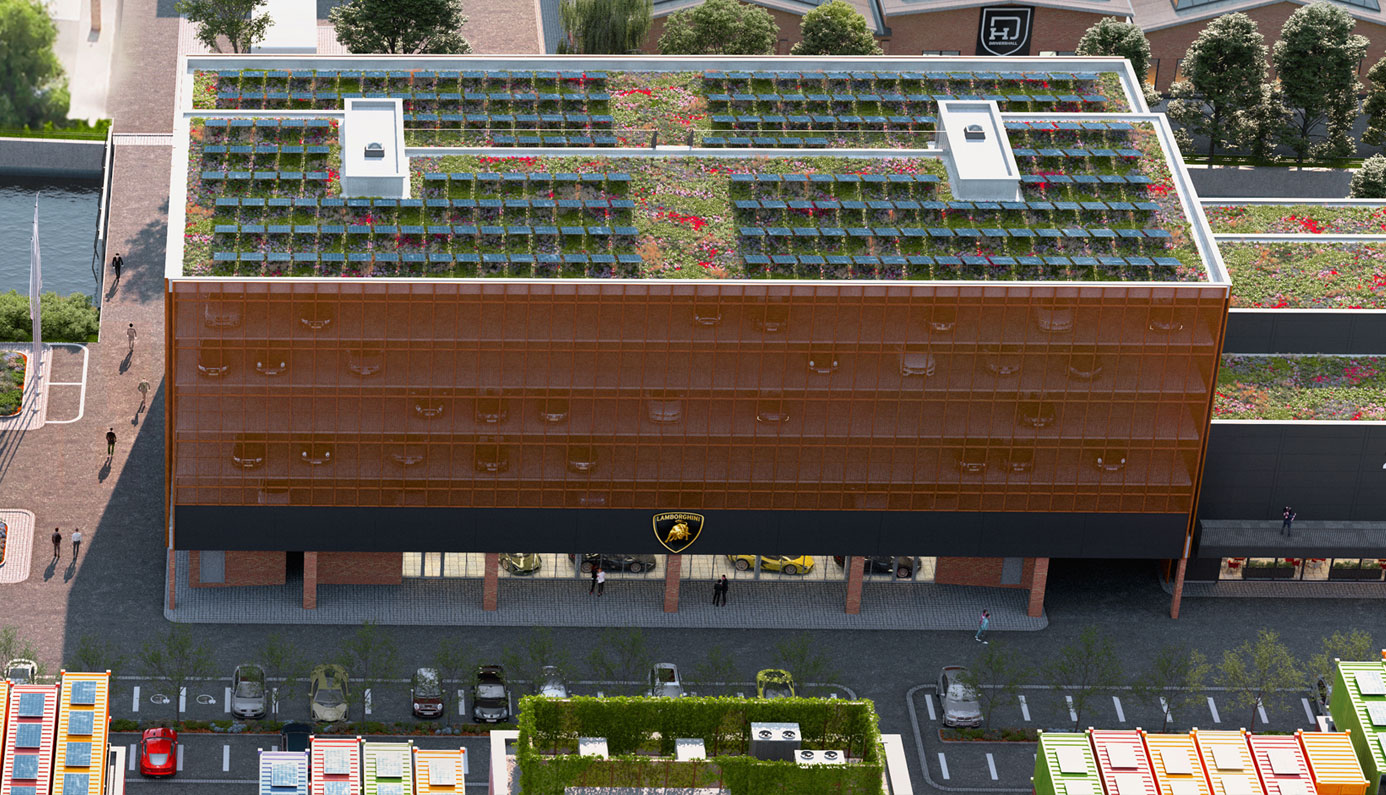 Modern building view with a large reflective façade reflecting cars and people, solar panels and green areas with flowers on the roof, a parking lot with several cars can be seen in the foreground, trees and other buildings in the background.