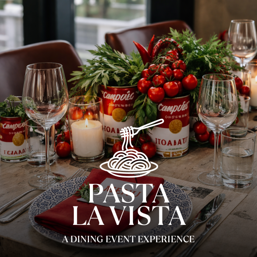 Tischgedeck mit Weingläsern, brennender Kerze, Dosen mit Tomaten und Kräutern, Teller mit roter Serviette und dem Schriftzug Pasta La Vista.